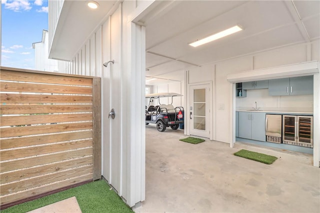 interior space featuring beverage cooler and sink