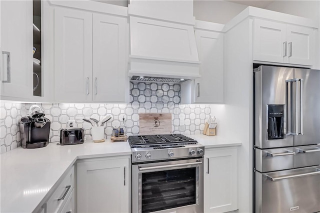 kitchen with white cabinets, backsplash, and stainless steel appliances