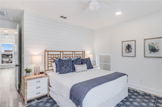 bedroom featuring wooden walls