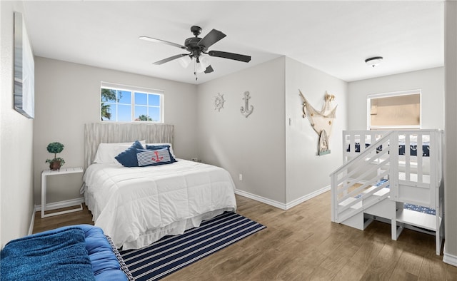 bedroom with ceiling fan and wood-type flooring