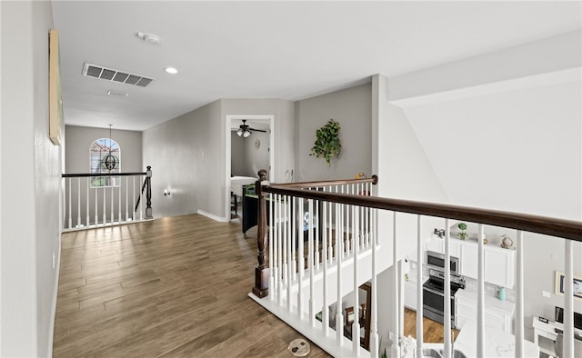 corridor with dark hardwood / wood-style flooring