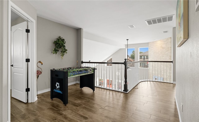 game room with dark wood-type flooring