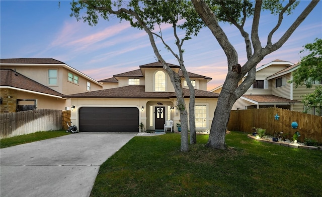 view of front of house with a garage and a lawn