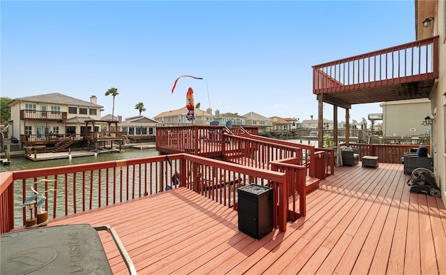 wooden terrace featuring a water view