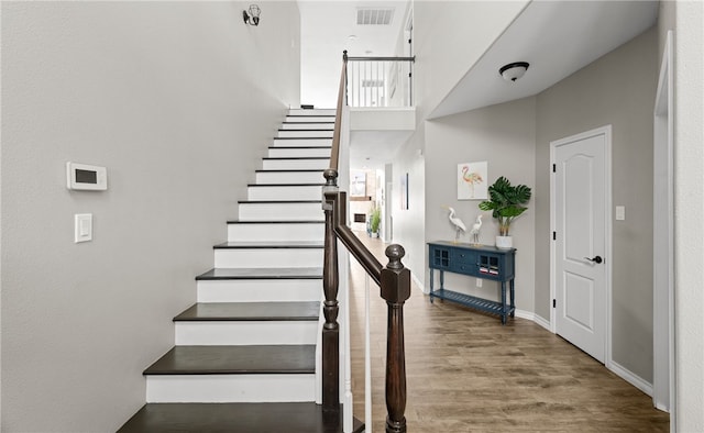 stairway with hardwood / wood-style flooring