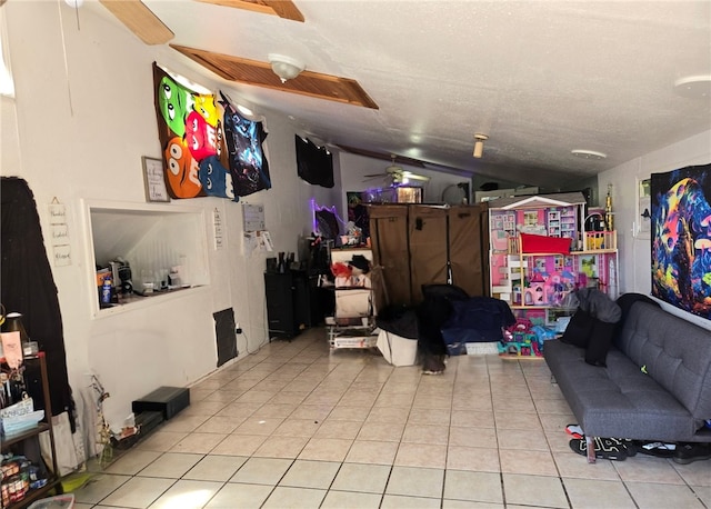 interior space featuring a textured ceiling, a ceiling fan, and tile patterned floors