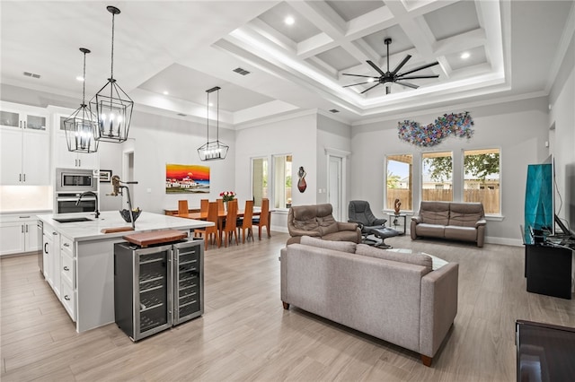 living room featuring a wealth of natural light, crown molding, ceiling fan, and light hardwood / wood-style flooring