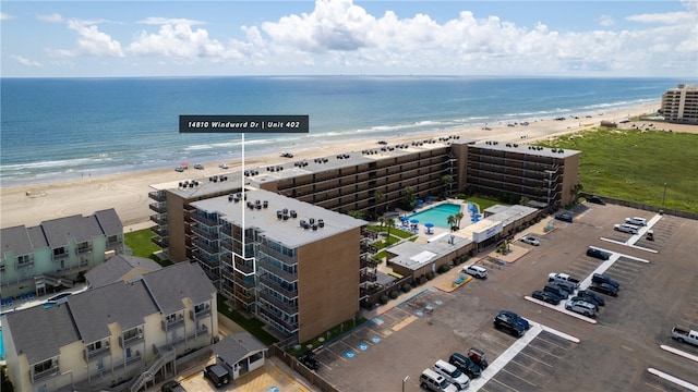 drone / aerial view featuring a beach view and a water view