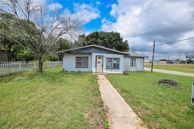 bungalow-style house with fence and a front yard