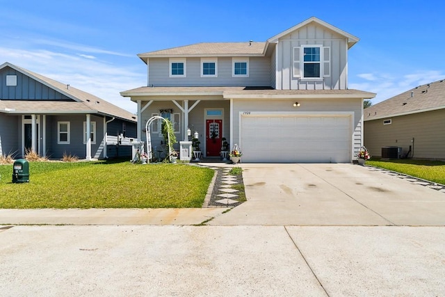 1928 Estes Flats Dr, Aransas Pass, TX 78336 - view of front facade featuring board and batten siding, a front lawn, a garage, concrete driveway, and central air condition unit