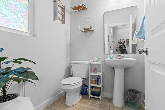 1928 Estes Flats Dr, Aransas Pass, TX 78336 - half bath with toilet, baseboards, and wood finished floors
