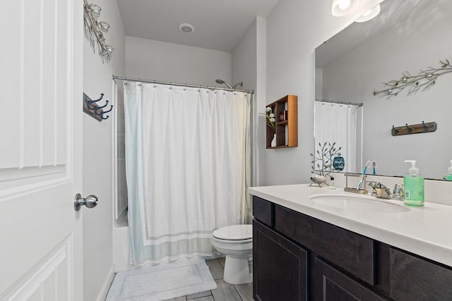 1928 Estes Flats Dr, Aransas Pass, TX 78336 - bathroom featuring toilet, vanity, and shower / tub combo with curtain