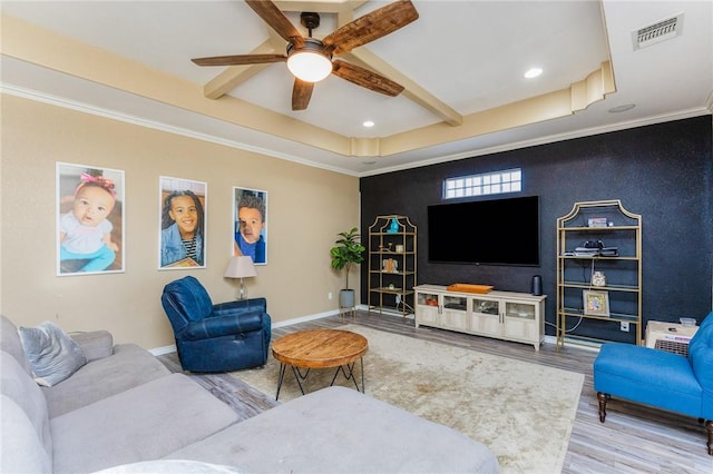 living area with baseboards, visible vents, wood finished floors, beamed ceiling, and crown molding