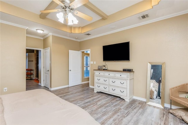 bedroom with a tray ceiling, baseboards, visible vents, and light wood finished floors