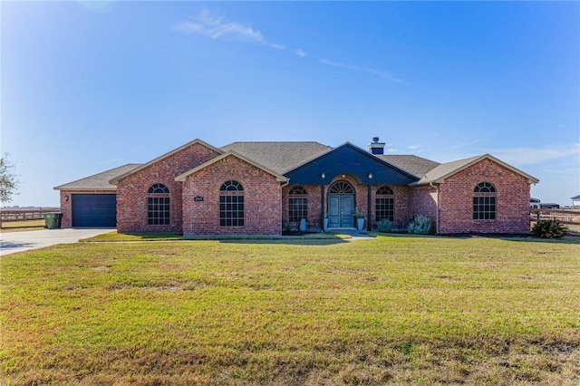 single story home with brick siding, a chimney, concrete driveway, an attached garage, and a front lawn