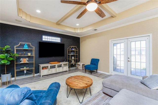 living room featuring french doors, beamed ceiling, baseboards, and wood finished floors