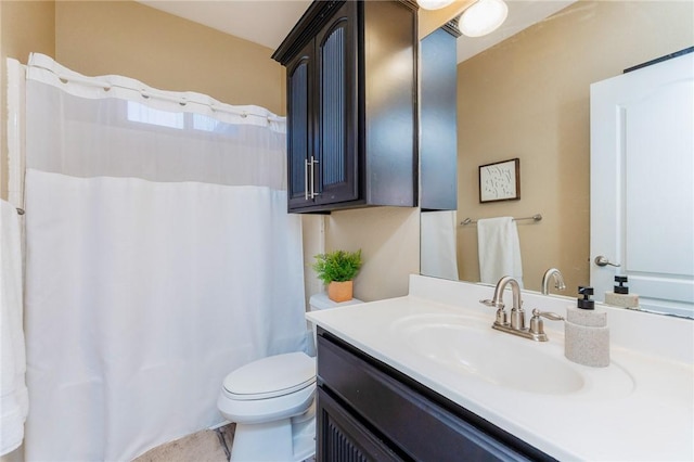 bathroom featuring toilet, vanity, and a shower with curtain