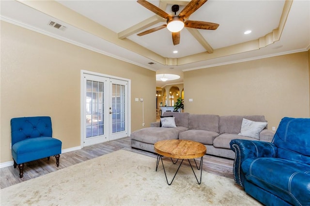 living area with arched walkways, french doors, wood finished floors, beamed ceiling, and baseboards