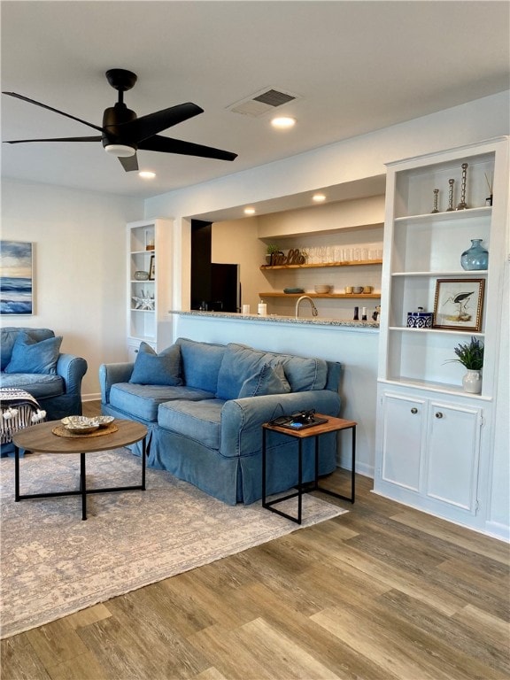 living room with hardwood / wood-style floors and ceiling fan