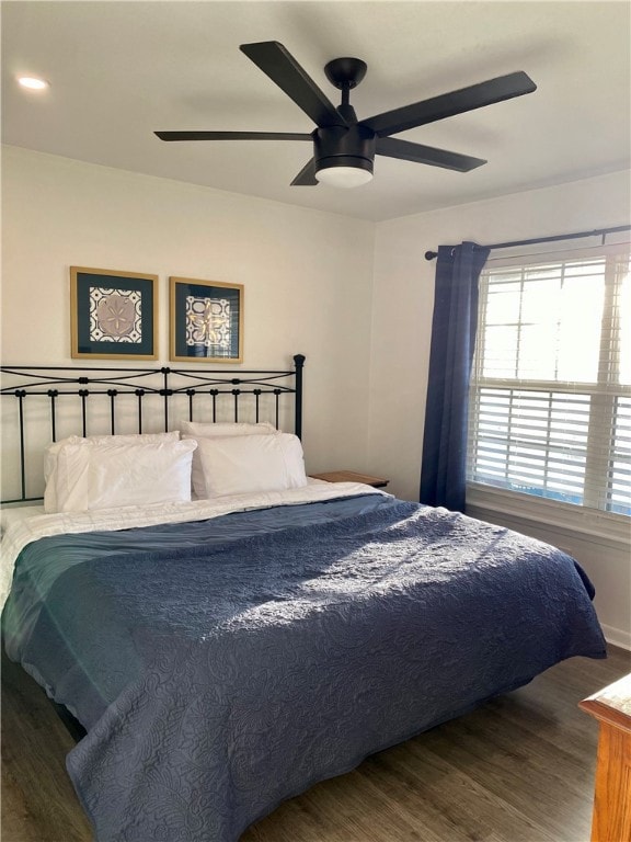 bedroom with hardwood / wood-style floors and ceiling fan