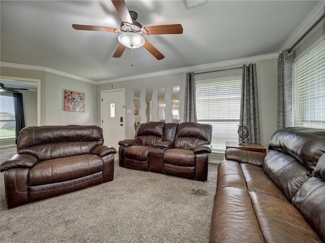 living room featuring ornamental molding, carpet, and a healthy amount of sunlight