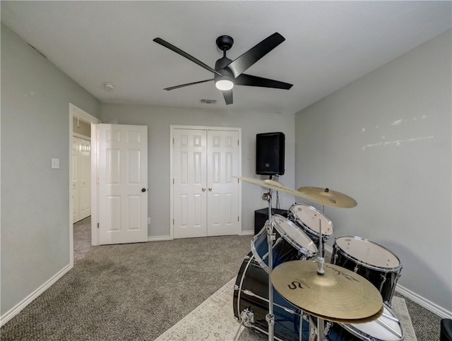 interior space featuring carpet flooring and ceiling fan