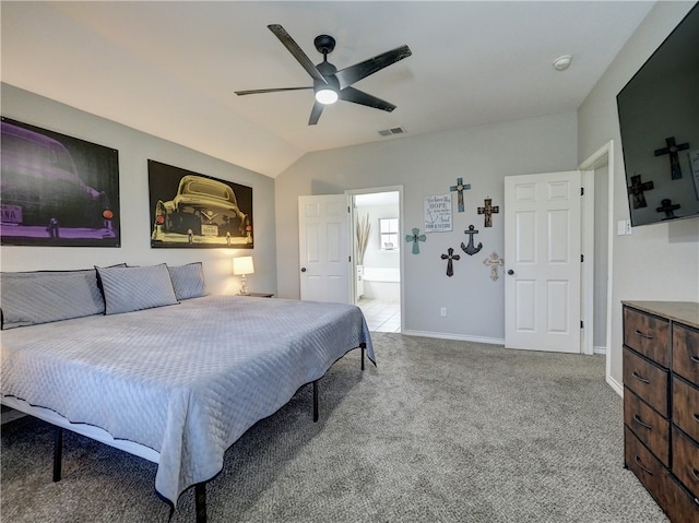 carpeted bedroom with vaulted ceiling, ceiling fan, and ensuite bathroom