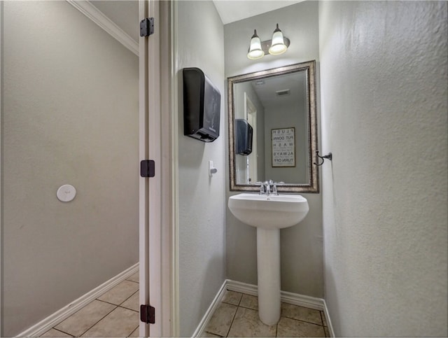 bathroom featuring tile patterned flooring and ornamental molding