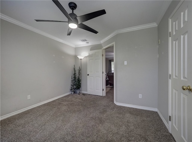 unfurnished bedroom featuring carpet, ceiling fan, and crown molding