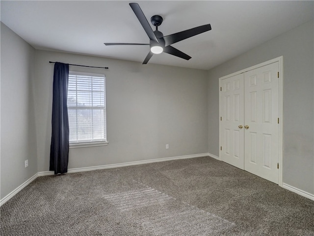 unfurnished bedroom with ceiling fan, a closet, and carpet floors