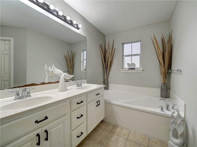 bathroom featuring a bathing tub, vanity, and tile patterned floors