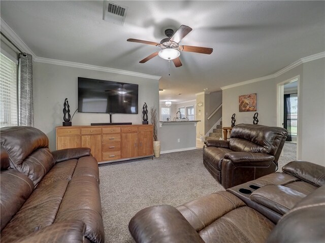 carpeted living room featuring ceiling fan and crown molding