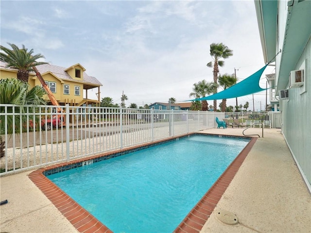 community pool featuring a patio area and a fenced backyard