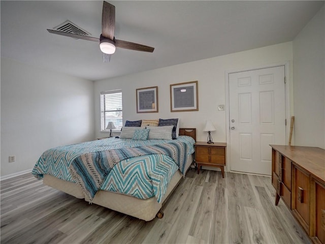 bedroom featuring light wood-style flooring, ceiling fan, and baseboards