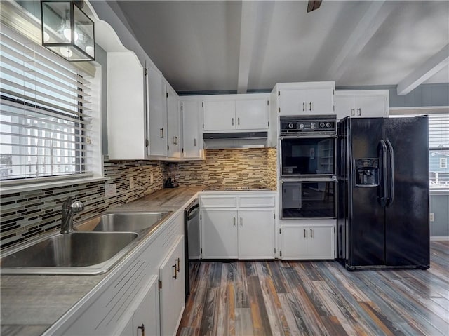 kitchen with black appliances, a sink, dark wood-style floors, beam ceiling, and tasteful backsplash