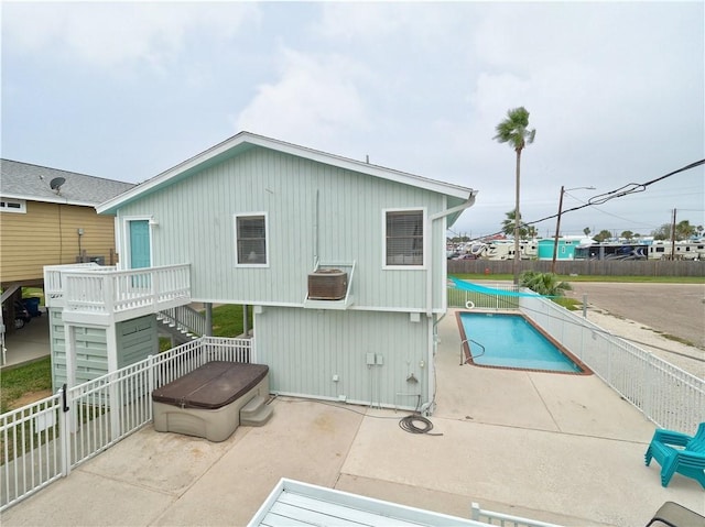 rear view of property featuring stairway, fence, and a patio area