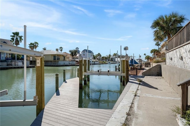 127 Sea Mist Dr, Aransas Pass, TX 78336 - dock area featuring boat lift, a water view, and a residential view