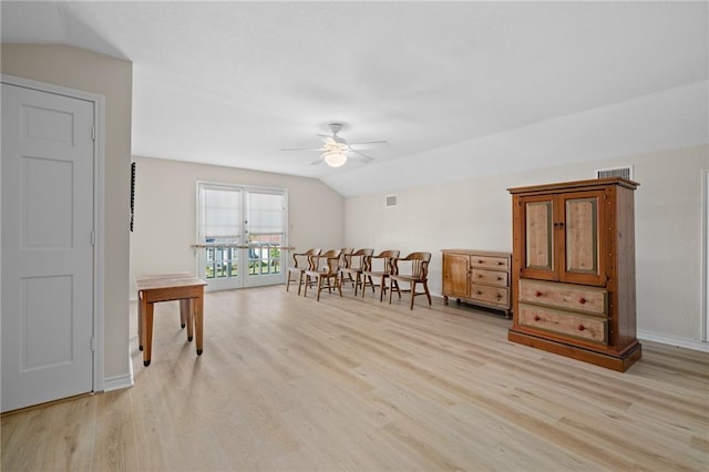 127 Sea Mist Dr, Aransas Pass, TX 78336 - dining room featuring lofted ceiling, a ceiling fan, light wood-style floors, and baseboards