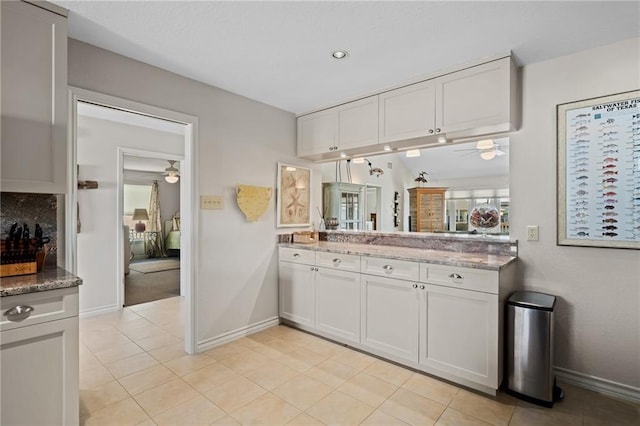 127 Sea Mist Dr, Aransas Pass, TX 78336 - kitchen with ceiling fan, baseboards, and white cabinetry