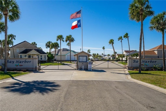 127 Sea Mist Dr, Aransas Pass, TX 78336 - view of asphalt road with a residential view, a gate, and curbs