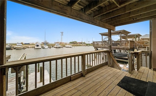 wooden terrace with a dock and a water view