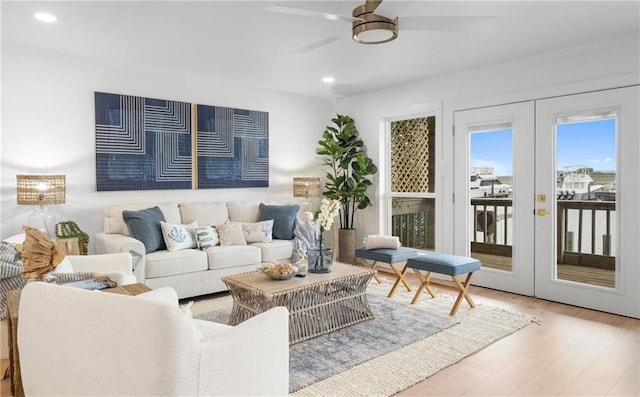 living room featuring hardwood / wood-style floors, ceiling fan, and french doors