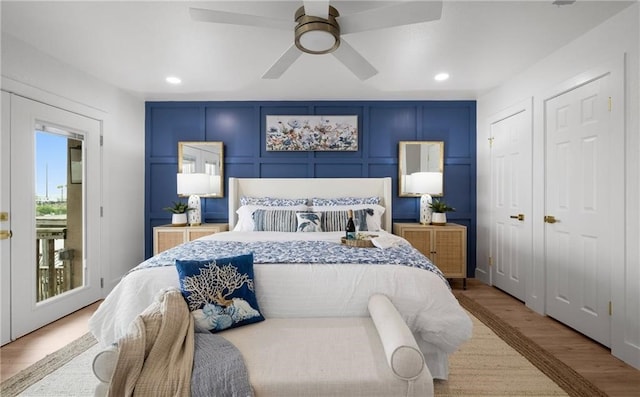 bedroom with ceiling fan and light hardwood / wood-style floors