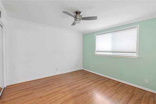 empty room featuring light hardwood / wood-style floors, ceiling fan, and crown molding