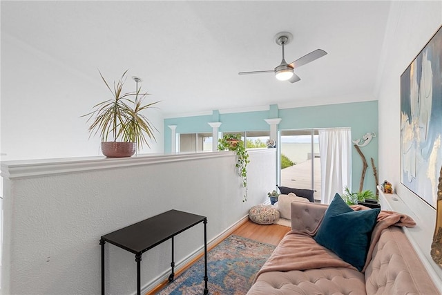 living room featuring wood-type flooring and ceiling fan