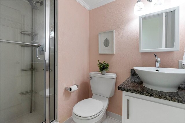 bathroom with crown molding, a shower with door, vanity, and toilet