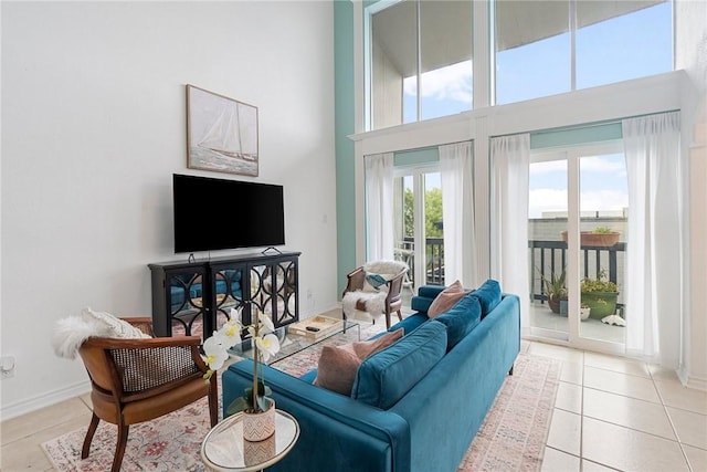 living room with light tile patterned floors and a towering ceiling