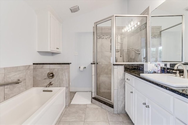 5241 Saint Andrews Dr, Corpus Christi, TX 78413 - bathroom with vanity, a garden tub, a shower stall, and baseboards