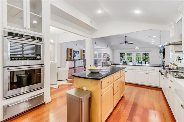 5241 Saint Andrews Dr, Corpus Christi, TX 78413 - kitchen with a warming drawer, appliances with stainless steel finishes, open floor plan, vaulted ceiling, and light wood finished floors