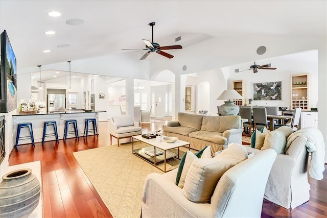 5241 Saint Andrews Dr, Corpus Christi, TX 78413 - living area featuring a ceiling fan, lofted ceiling, wood finished floors, arched walkways, and recessed lighting